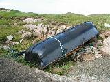 Currach beside the pier at the north end of the Cruit