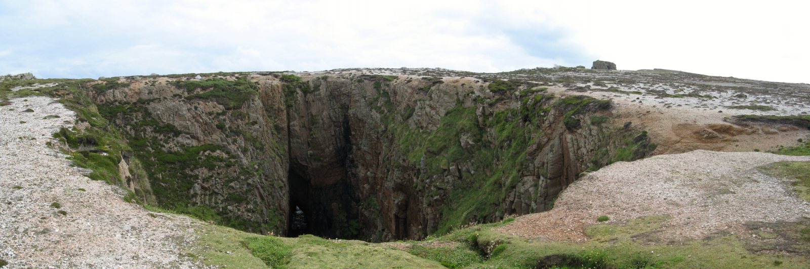 The land has collapsed into a tunnel eroded by the sea.