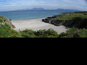 The island's bigger beach near the community center with Mweelrea, the highest mountain in Connacht, visible on the mainland.